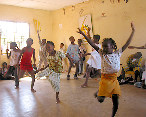 CHILDREN dancing at school.